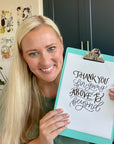 Woman holding a sign with 'Thank you for going above and beyond' text
